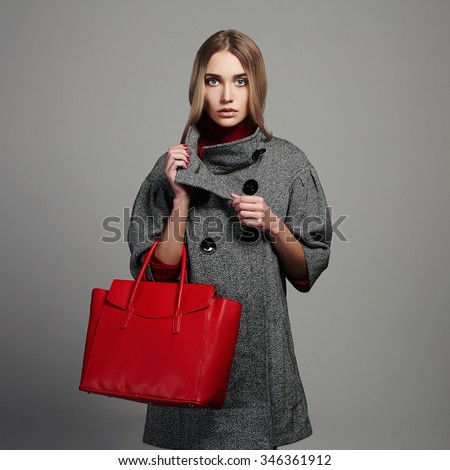 Winter beautiful Woman with Handbag.Beauty Fashion Girl in topcoat.Shopping