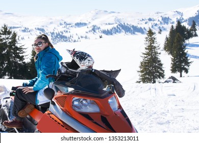 Winter, beautiful woman and a snowmobile, horizon format - Shutterstock ID 1353213011