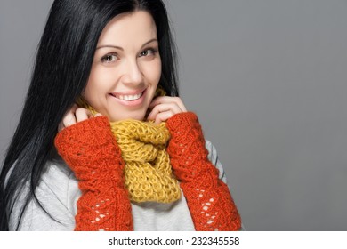 Winter Beauty Woman. Fashion Girl Concept. Skin And Hair Care In Cold Season. Beautiful Woman With Long Hair Wearing A Sweater, Scarf, Hat And Gloves. Holiday Fashion Portrait.