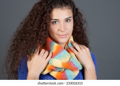 Winter Beauty Woman. Fashion Girl Concept. Skin and hair care in cold season. Beautiful woman with long hair wearing a sweater, scarf, hat and gloves.