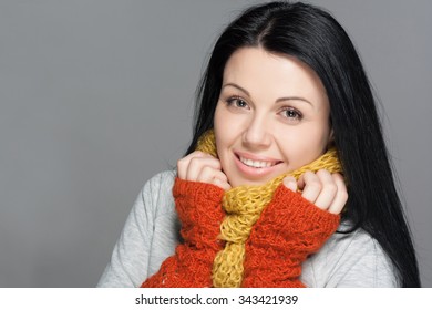 Winter Beauty Woman. Fashion Girl Concept. Skin And Hair Care In Cold Season. Beautiful Woman With Long Hair Wearing A Sweater, Scarf, Hat And Gloves. Holiday Fashion Portrait.