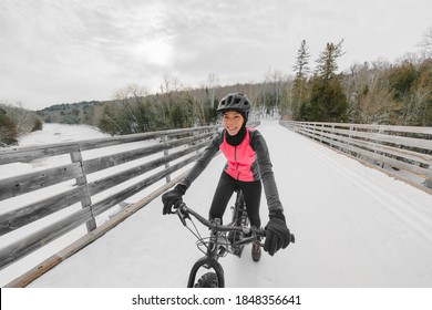 Winter Bike Sport Fun Happy Cyclist Asian Girl Cycling On Snow Bridge With Fat E-bike. Electric Biking.