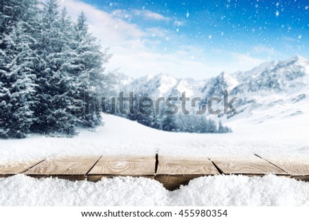 winter blue landscape of alps and brown old table of wood and snow place 