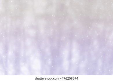 Winter blur background with snowflakes in motion with a pastel multi colored gradient