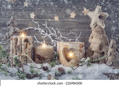 Winter Candles On A Wooden Background