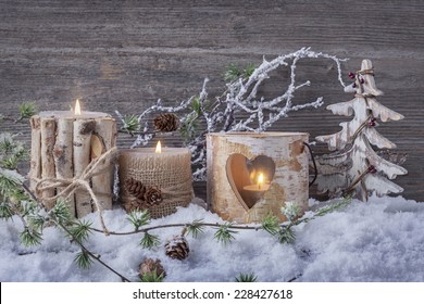 Winter Candles On A Wooden Background