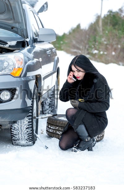 Winter car break down - woman call for help,\
road assistance