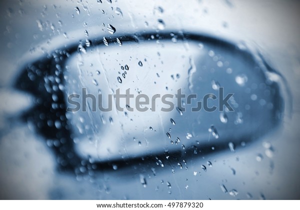 Winter car, the concept of winter car\
ride. Mirror and ice and water drops on the\
windscreen.