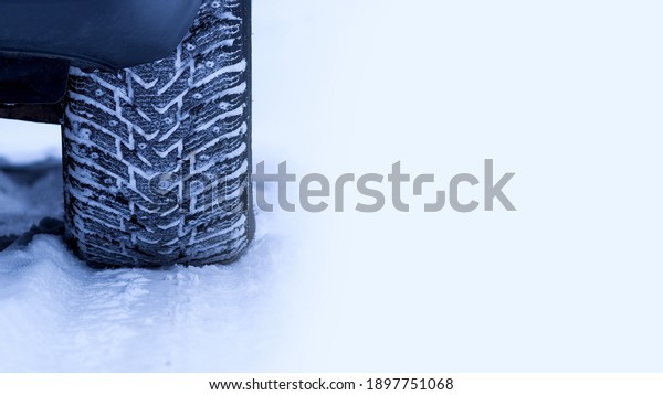 Winter. The car has wheels with winter tires and\
spikes. As conceived by the author, part of the photo is out of\
focus and blurry.