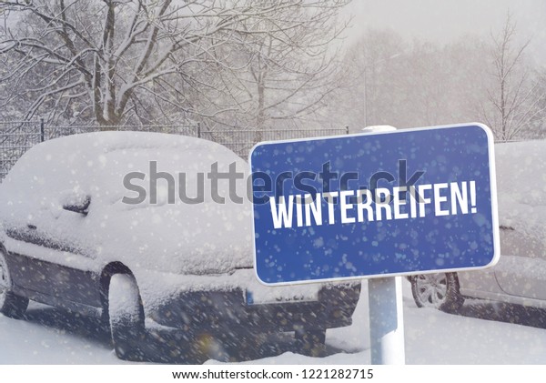 Winter, a car and a sign with the german word for\
winter tires