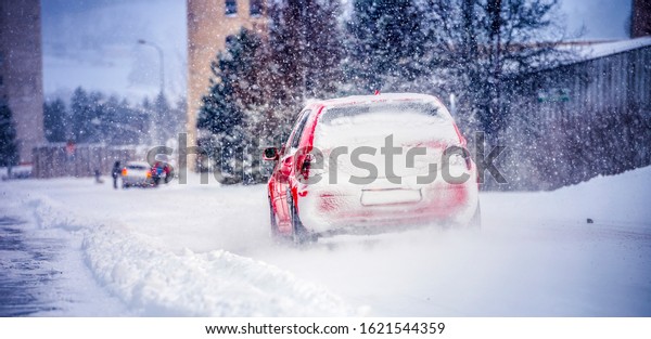 Winter car; Snow; Blizzard. Poor visibility on the\
road. Car during a Blizzard on the road with the headlights.\
Countryside during snow\
storm.