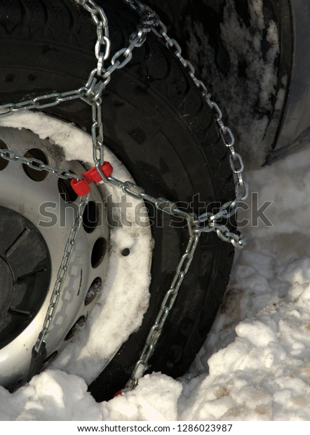 Winter Car Tire With\
Chains In Deep Snow