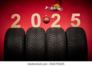 Winter car tires, big wheels service and hand of mechanic man with wrench and christmas ball on red background - Powered by Shutterstock