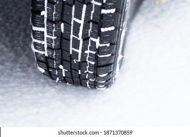 Winter Car Tires In The Snow. Safe Driving Concept.