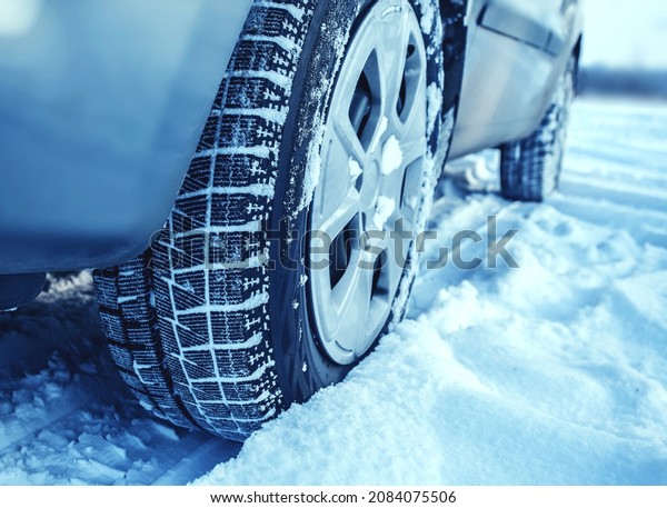 Winter car tyres on a snowy\
road