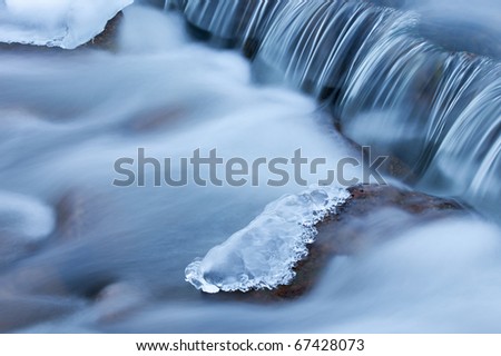 Winter cascade framed by ice, Orangeville Creek, Michigan, USA