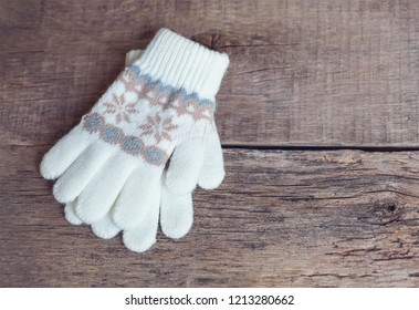 Winter Children's Mittens Lie On A Wooden Background. Hygge.