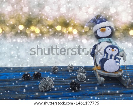 winter christmas background with penguin decor snow on blue wooden texture                              