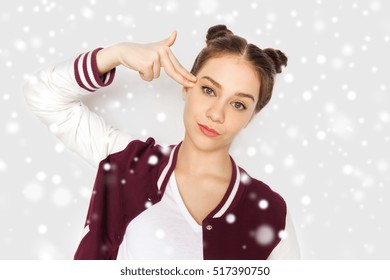 Winter, Christmas, People, Stress And Gesture Concept - Bored Teenage Girl Making Headshot By Finger Gun Gesture Over Gray Background And Snow