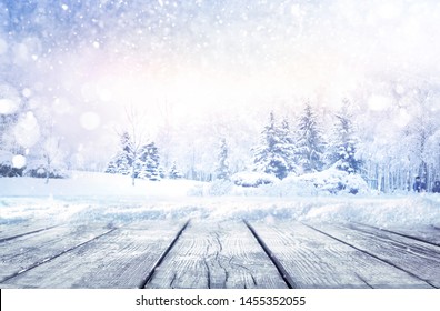 Winter Christmas Scenic Landscape With Copy Space. Wooden Flooring Strewn With Snow In Forest  With Fir-trees Covered With Snow On Nature.