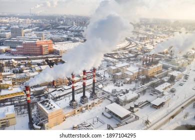 In the winter city, the factory's chimneys are smoking. The concept of air pollution. Environmental pollution by industrial waste.