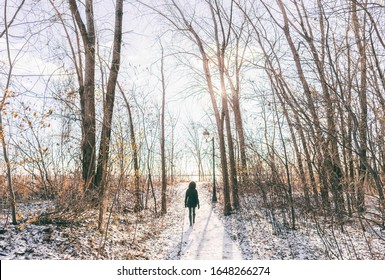 Winter City Park Outdoor Walk Woman Walking In Snow In Snowy Forest Path In Sunny Day, Active People. Outside Leisure. Girl Hiking In Nature.