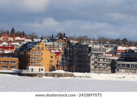 Winter in the city of Östersund. A winter's day in Sweden. The sun is shining towards the center of the city with newly built houses.