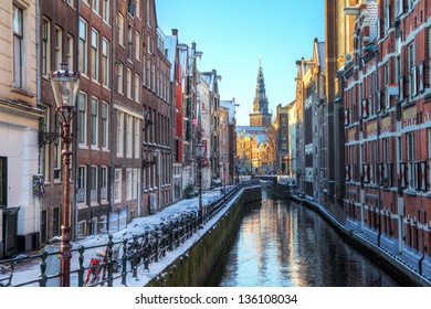 Winter cityscape of the Oudezijds kolk in Amsterdam, the Netherlands, with the Oude Kerk (old church, 1213) in the background. HDR