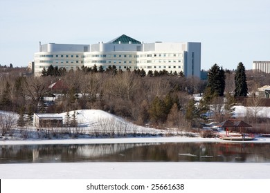 A Winter Cityscape Of The South Saskatchewan River In Saskatoon, Canada Featuring The City Of Saskatoon Hospital.