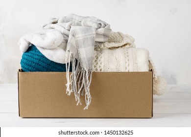 Winter Clothes In A Cardboard Box. Seasonal Clothing For Shipping Or Donation.