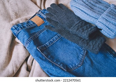 Winter Clothes Outfit. Comfy Women's Clothing. Beige Sweater, Blue Jeans, Knitted Hat And Gray Gloves 