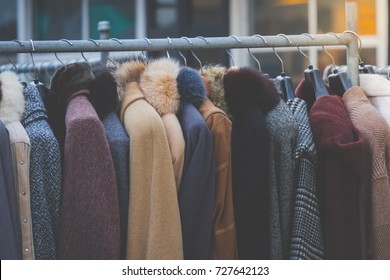 Winter coats hanged on a clothes rack.
