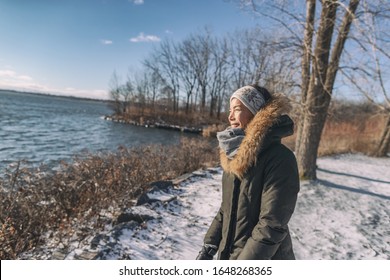 Winter Cold Asian Woman Happy Smiling In Cold Weather On Outdoor Walk Sunlight In Forest Nature Active Healthy Lifestyle. Young Girl Enjoying Outside Leisure Walking.