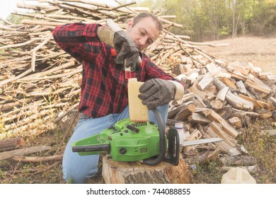 Winter is coming - lumberjack maintaining chainsaw outdoors. - Powered by Shutterstock