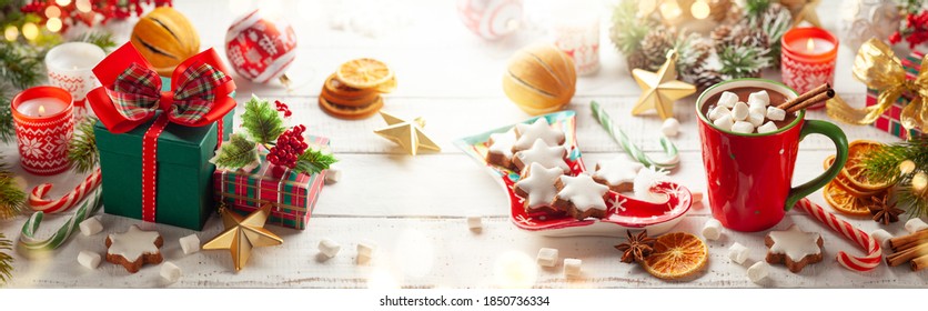 Winter composition with Christmas gift boxes, holiday food and drink and Christmas decorations on wooden table. - Powered by Shutterstock