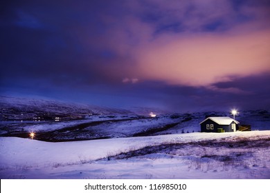 Winter Cottage in Snow with Dramatic Clouds at Night - Powered by Shutterstock