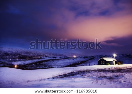 Winter Cottage in Snow with Dramatic Clouds at Night