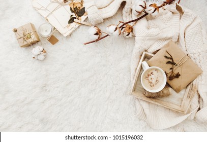 Winter cozy background with cup of coffee, warm sweater and old letters. Flat lay for bloggers