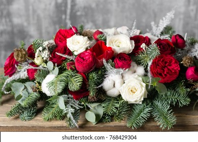 Winter Decor. The Composition Of The Branches Nobilis And Fresh Flowers. Work Florist In Shop. For Decorating A Family Dinner