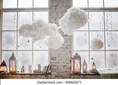 Winter Decor On Windowsill With Lanterns And Clouds