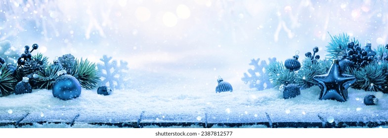 Winter decoration with a blue star and snowflakes on a snowy landscape background
