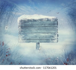 Winter design background - Christmas valley with sign for copyspace. Wooden sign in snow valley with woods,  tree, rabbit, holly and bird. Space for your winter text. Winter background - Powered by Shutterstock