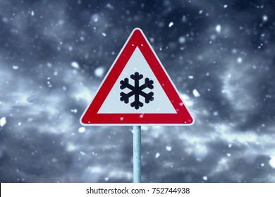 winter driving - snowfall on the road -  warning sign 