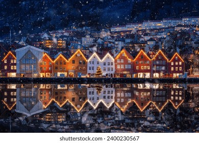 Winter dusk view of the famous Bryggen district at Bergen, Norway, decorated for Christmas with snow - Powered by Shutterstock