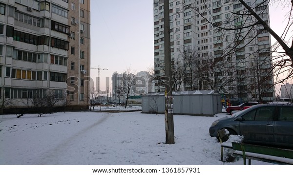 winter\
evening of east Europe with gloomy gray\
buildings