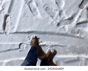 Winter Exploration: A Person's First Steps on Fresh Snow-Covered Ground - Powered by Shutterstock