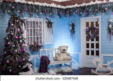 Winter Exterior Of A Country House With Christmas Decorations In The Florida Style. Snow-covered Country Patio, Tree And Wooden Bench.