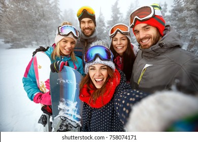 Winter, Extreme Sport And People Concept - Happy Friends Having Fun On The Snow And Making Selfie