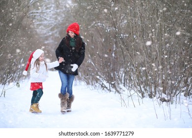 Winter fairy tale in the forest. A girl on a sled with gifts on the eve of the new year in the park. Two sisters walk in a New Year's park and ride a sled with gifts.
 - Powered by Shutterstock