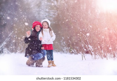 Winter fairy tale, a young girls ride a sled in the forest. 